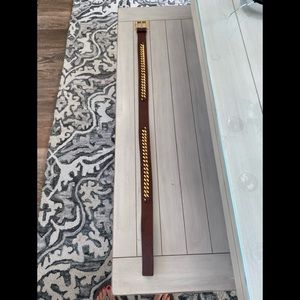 Wide brown and gold leather belt.